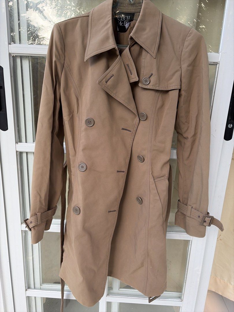 Cecil McBee Double Breasted Trench Coat (Category: Coats, Jackets and Outerwear) located in Bulacan. Submitted by aarchive (Listing ID 1463322826, Image 1). Description: - Classic Cecil McBee trench coat - Double-breasted style - Includes a belt to cinch the waist - Button details on front and cuffs - Features a back storm flap - Ideal for layering over any outfit - A timeless addition to your wardrobe -Stitchings on the buttons are slightly loos