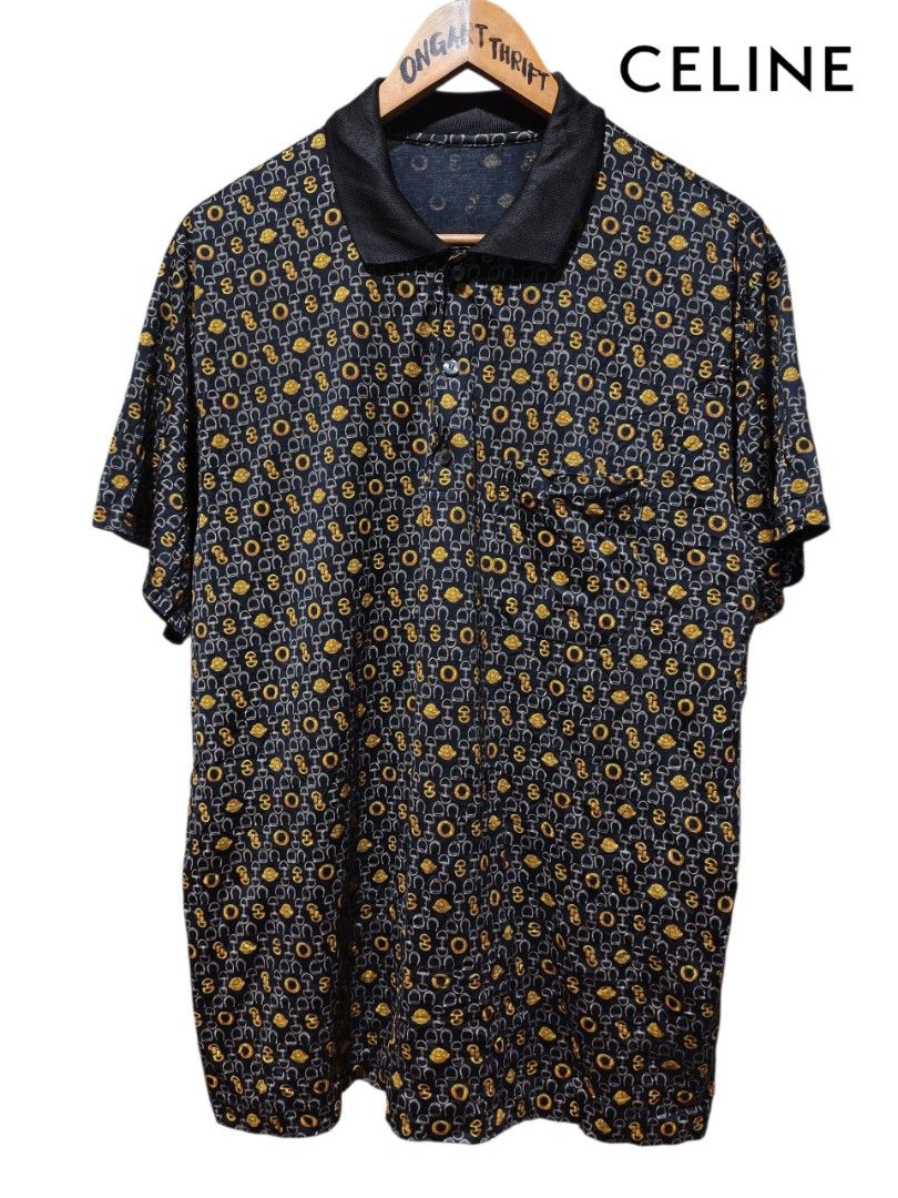 CELINE All Over Print Polo Shirt (Category: Tshirts & Polo Shirts ) located in Maasim. Submitted by ukayganda25 (Listing ID 1463299598, Image 1). Description: - Classic CELINE polo shirt - Iconic all-over print featuring horseshoe and 'CELINE PARIS' motifs - Dark navy base with elegant gold and grey details - Black collar and button-up front - Perfect for a stylish casual look - Attention to detail on buttons and print.