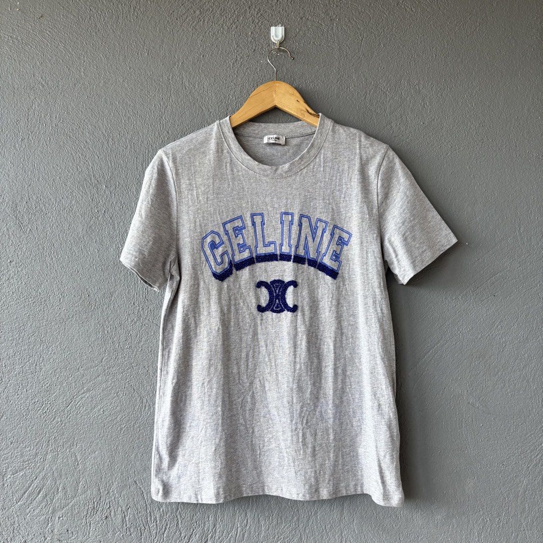Celine tee (Category: Shirts) located in San Fernando. Submitted by diff.thr1ft (Listing ID 1463166026, Image 1). Description: - Brand: Celine - Color: Heather Grey - Size: Medium (M) - Design: Features iconic Celine logo with intricate beadwork - Material: Comfortable cotton blend - Condition: Excellent, pre-loved - Style: Casual, chic, Parisian-inspired.