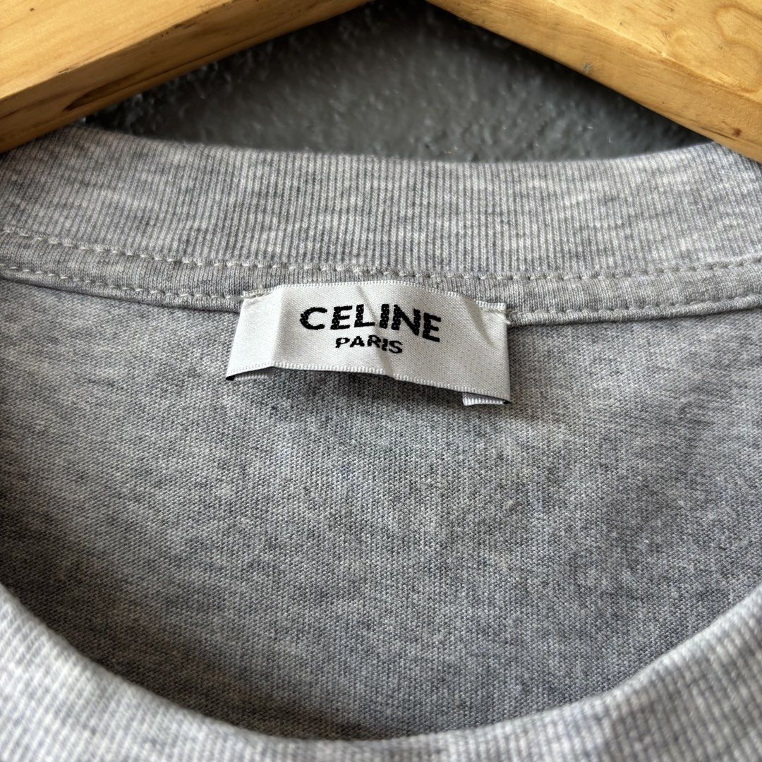 Celine tee (Category: Shirts) located in San Fernando. Submitted by diff.thr1ft (Listing ID 1463166026, Image 3). Description: - Brand: Celine - Color: Heather Grey - Size: Medium (M) - Design: Features iconic Celine logo with intricate beadwork - Material: Comfortable cotton blend - Condition: Excellent, pre-loved - Style: Casual, chic, Parisian-inspired.
