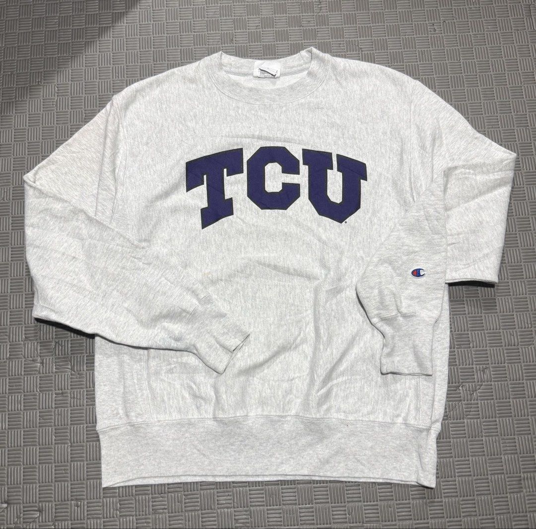 Champion TCU Reverse Weave Crewneck Sweatshirt Medium (Category: Coats, Jackets and Outerwear) located in Baguio. Submitted by MysticVaultPh (Listing ID 1463291633, Image 1). Description: - Grey Champion Reverse Weave sweatshirt - Features large navy blue 'TCU' graphic on the front - Classic crewneck style with long sleeves - Small Champion 'C' logo on the left sleeve cuff - Ideal for TCU fans or casual wear.