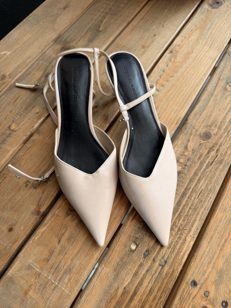 Charles & Keith Beige Pointed Toe Slingback Heels (Category: Heels) located in Tuguegarao City. Submitted by joysmithznjo (Listing ID 1463203299, Image 1). Description: - Brand: Charles & Keith - Color: Beige - Style: Pointed toe slingback heels - Features: Thin ankle strap with buckle closure, low heel - Versatility: Perfect for dressing up or down.