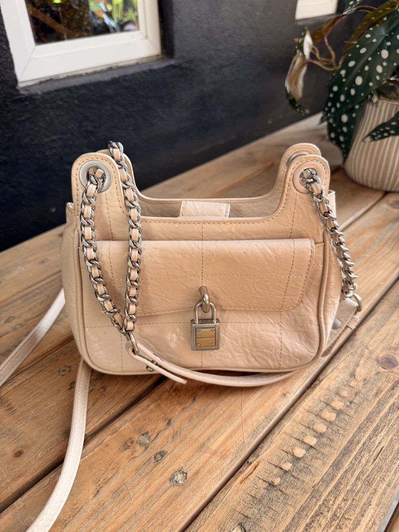Charles & Keith Beige Quilted Chain Shoulder Bag with Lock (Category: Shoulder Bags) located in Tuguegarao City. Submitted by joysmithznjo (Listing ID 1463204476, Image 3). Description: - Beige shoulder bag from Charles & Keith - Features a quilted front flap with a cute lock detail - Stylish chain strap for an edgy touch - Interior compartments for easy organization - Versatile for everyday use or nights out.