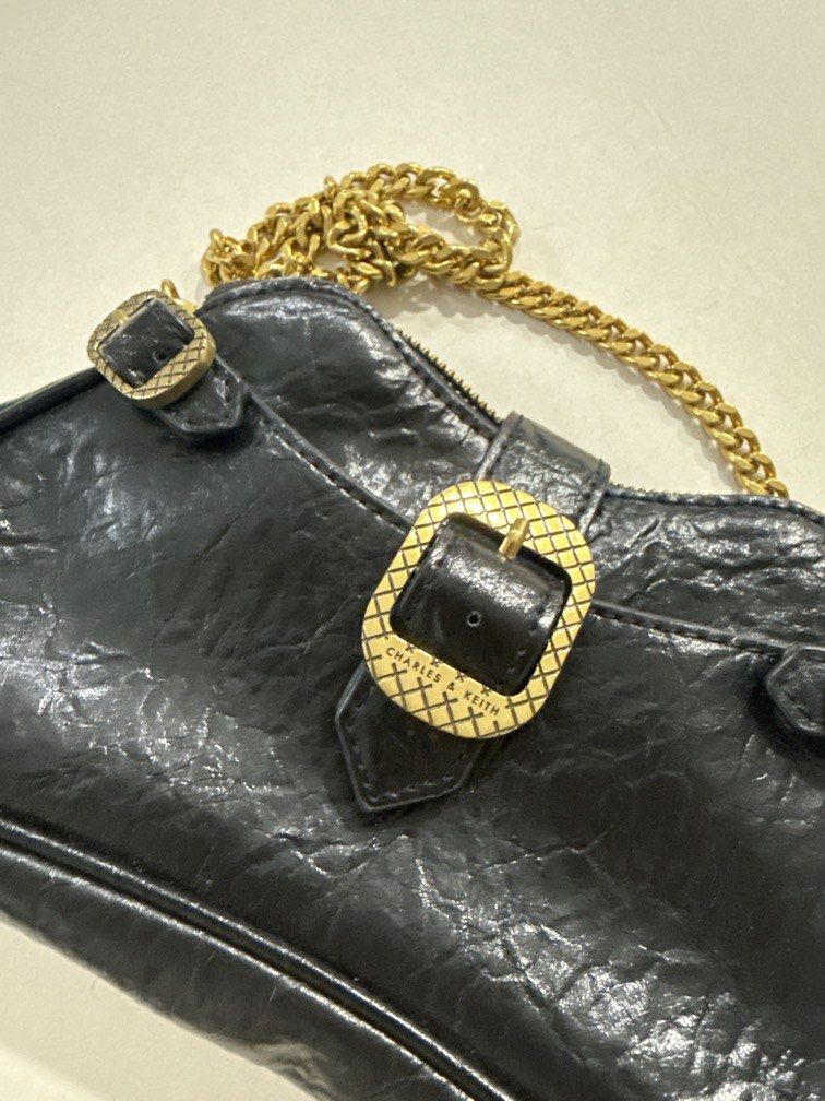 Charles & Keith black shoulder/crossbody bag (Category: Shoulder Bags) located in Taguig. Submitted by darjaromanova (Listing ID 1463183335, Image 3). Description: Black leather shoulder/crossbody bag with gold-tone chain details. • Black leather finish • Gold-tone hardware and chain strap • Comes with both chain and adjustable leather strap • Zipper closure • Classic design that goes with everything • Good pre-loved condition Please check the ph