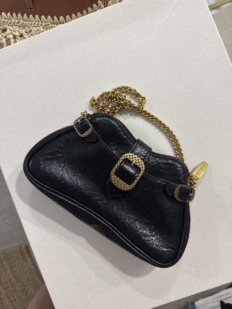Charles & Keith black shoulder/crossbody bag (Category: Shoulder Bags) located in Taguig. Submitted by darjaromanova (Listing ID 1463183335, Image 2). Description: Black leather shoulder/crossbody bag with gold-tone chain details. • Black leather finish • Gold-tone hardware and chain strap • Comes with both chain and adjustable leather strap • Zipper closure • Classic design that goes with everything • Good pre-loved condition Please check the ph