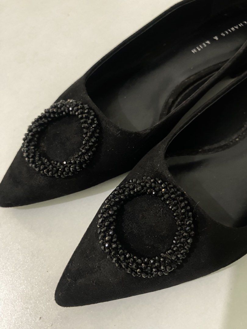 Charles & Keith Black Suede Embellished Heels (Category: Flats & Sandals) located in Manila. Submitted by wildocean-ff89 (Listing ID 1463206159, Image 1). Description: - Brand: Charles & Keith - Material: Black Suede - Style: Pointed-toe heels - Feature: Circular embellishment on the front - Heel Type: Low block heel - Closure: Slip-on - Versatile: Perfect for dressing up or down.