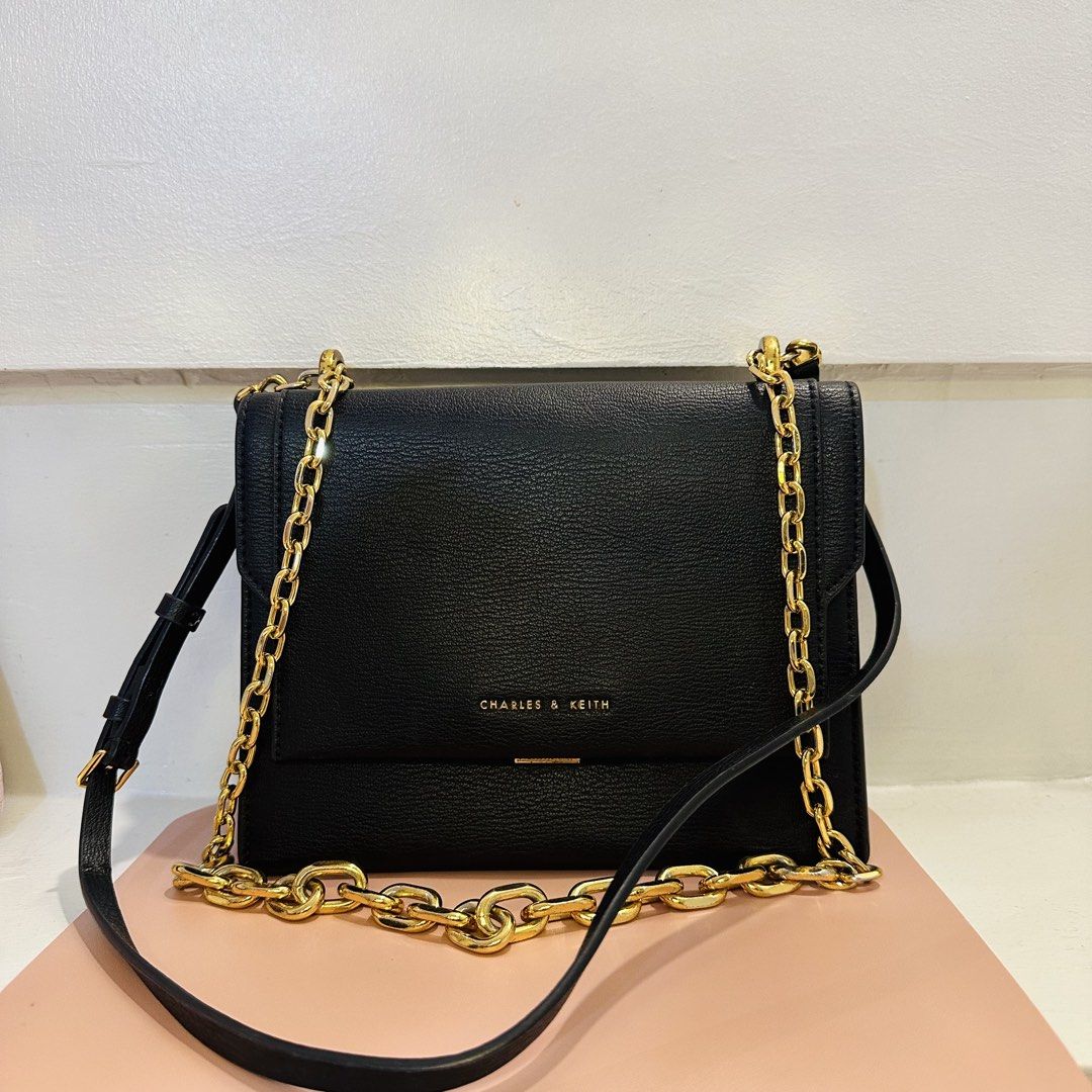 Charles & Keith Chain Handle Crossbody Bag - Black (Category: Cross-body Bags) located in Makati City. Submitted by xiaolongbabi (Listing ID 1463182485, Image 2). Description: Chatles & Keith Brennan Chain Handle Crossbody Bag ‼️ Elegant gold chain handle — can be worn as a shoulder or crossbody bag ‼️ - adjustable strap - 1 inner compartment - 1 zip compartment - 3 card slots Condition: 8.5/10 - used but still in good condition, well-mentained, 