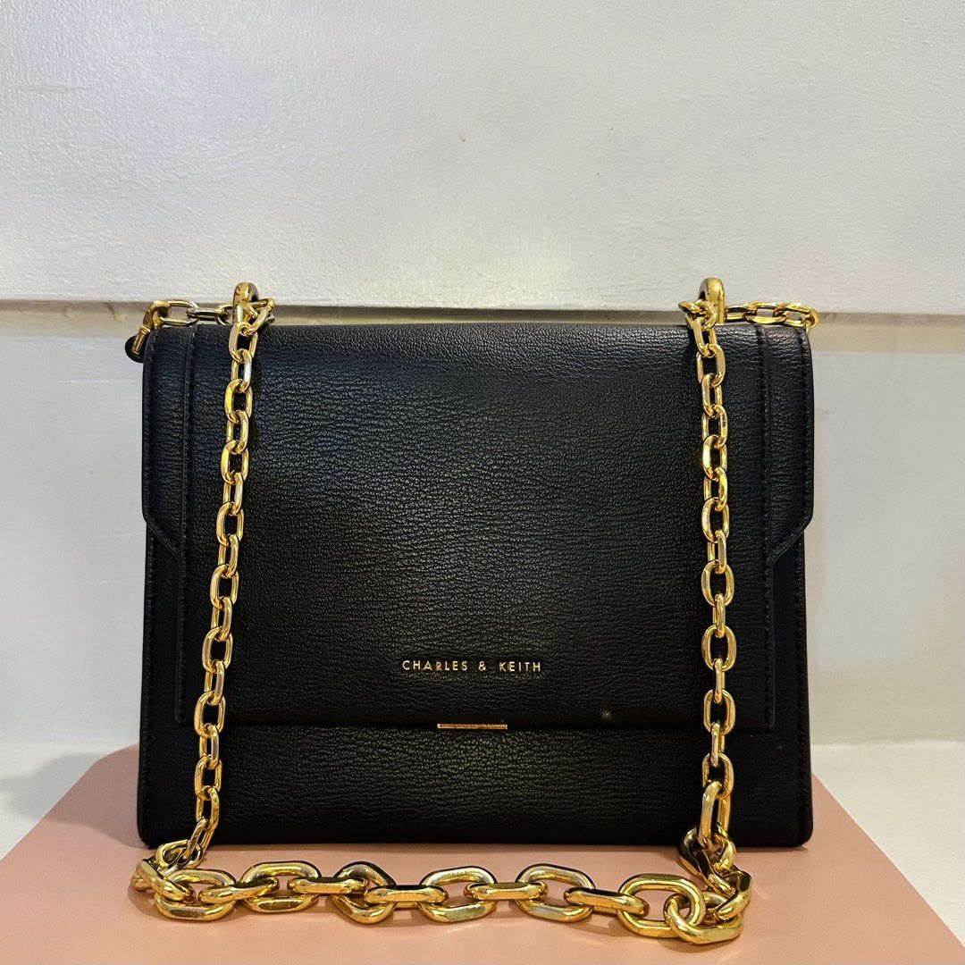 Charles & Keith Chain Handle Crossbody Bag - Black (Category: Cross-body Bags) located in Makati City. Submitted by xiaolongbabi (Listing ID 1463182485, Image 1). Description: Chatles & Keith Brennan Chain Handle Crossbody Bag ‼️ Elegant gold chain handle — can be worn as a shoulder or crossbody bag ‼️ - adjustable strap - 1 inner compartment - 1 zip compartment - 3 card slots Condition: 8.5/10 - used but still in good condition, well-mentained, 