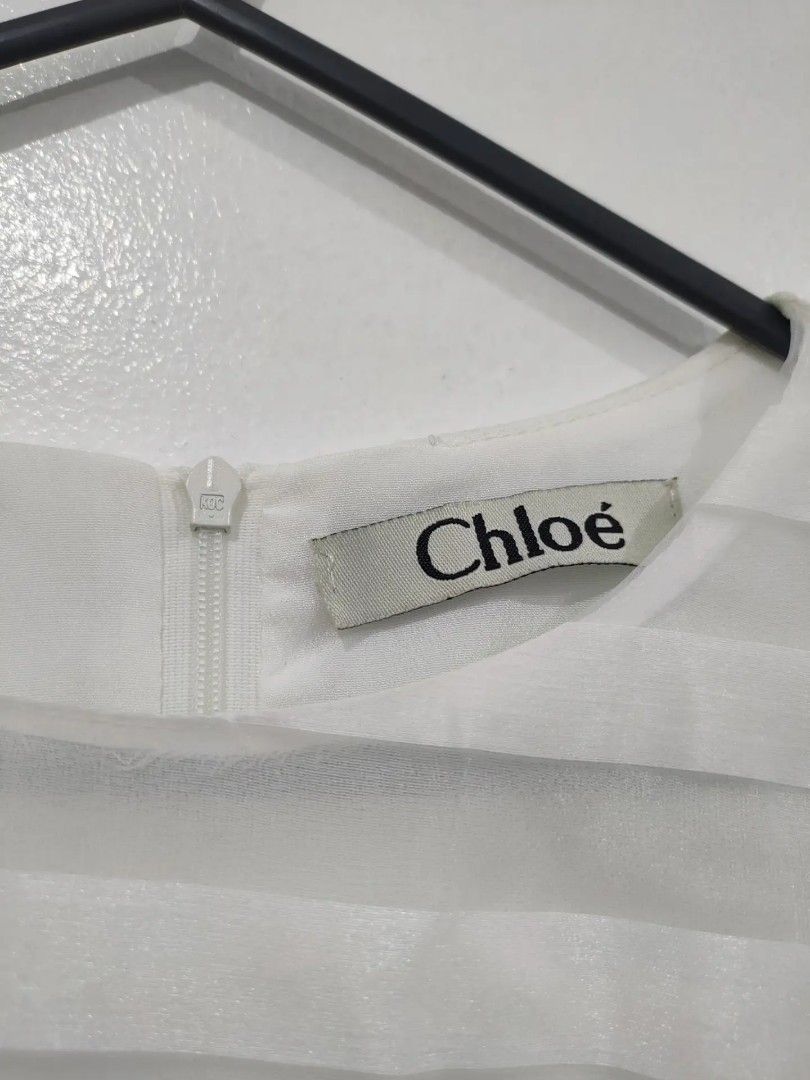 Chloe White Sheer Striped Dress (Category: Dresses) located in Quezon City. Submitted by maxsab (Listing ID 1463190079, Image 3). Description: - Elegant white Chloe dress - Features sheer horizontal stripes with textured details - Short sleeves adorned with delicate pearl embellishments - Convenient back zipper closure - Simple yet chic design - Versatile for any occasion.