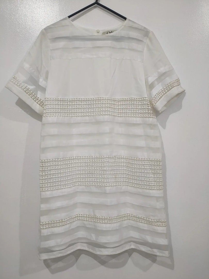 Chloe White Sheer Striped Dress (Category: Dresses) located in Quezon City. Submitted by maxsab (Listing ID 1463190079, Image 1). Description: - Elegant white Chloe dress - Features sheer horizontal stripes with textured details - Short sleeves adorned with delicate pearl embellishments - Convenient back zipper closure - Simple yet chic design - Versatile for any occasion.