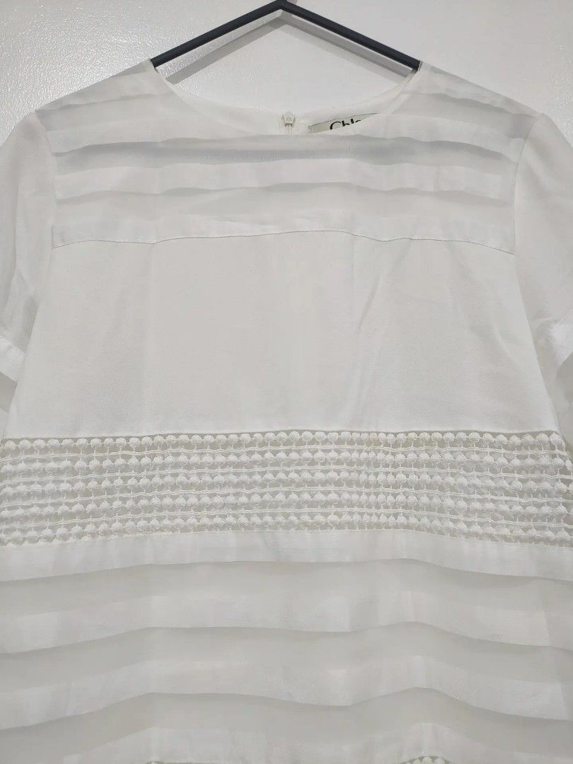 Chloe White Sheer Striped Dress (Category: Dresses) located in Quezon City. Submitted by maxsab (Listing ID 1463190079, Image 2). Description: - Elegant white Chloe dress - Features sheer horizontal stripes with textured details - Short sleeves adorned with delicate pearl embellishments - Convenient back zipper closure - Simple yet chic design - Versatile for any occasion.