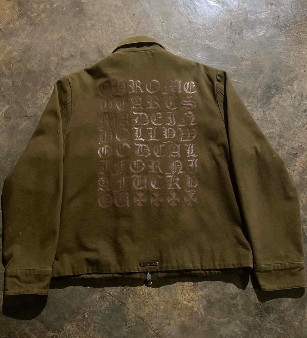 Chrome Hearts Canvass Work Jacket Olive Green (Category: Coats, Jackets and Outerwear) located in Valencia. Submitted by jscurated (Listing ID 1463253263, Image 2). Description: - Olive Green Chrome Hearts Work Jacket - Features iconic Chrome Hearts logo and text graphic on the back - Unique zipper pull and button details for added style - A must-have addition to any Chrome Hearts collection -Canvass Type Jacket.