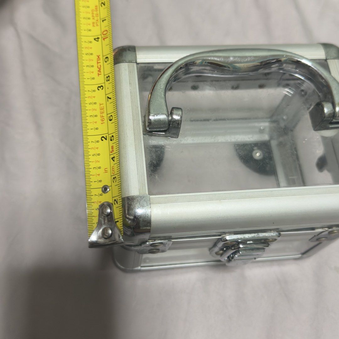 Clear Aluminum Trim Storage Box with Handle (Category: Storage Boxes & Baskets) located in Cebu City. Submitted by eynjlin (Listing ID 1463286511, Image 3). Description: - Small clear storage box - Silver aluminum trim - Sturdy metal handle on top - Secure latch closure at the front - Ideal for organizing small items, makeup, or craft supplies - Compact and easy to carry.