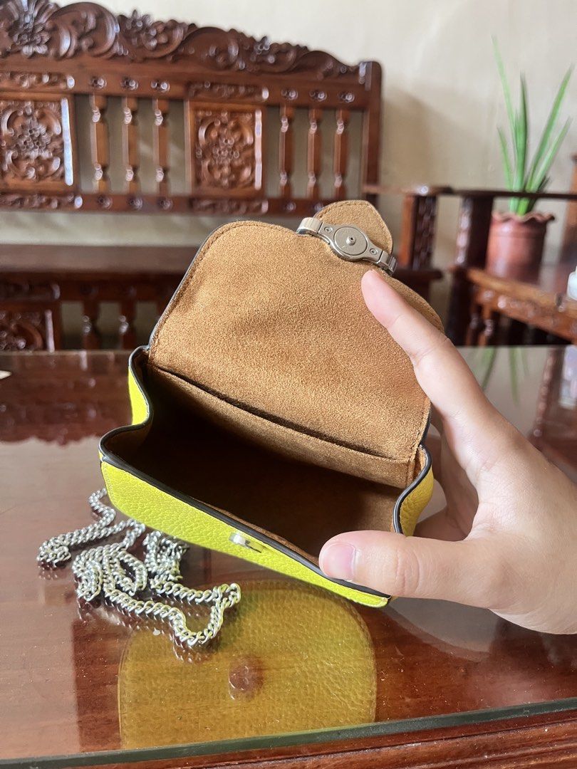 Coach Morgan Card Case on Chain in Lime (Category: Luxury Bags & Wallets) located in Dinalupihan. Submitted by penaflorcj (Listing ID 1463142497, Image 3). Description: - Authentic Coach - Pebble leather texture - Silver chain strap - Coach New York logo on buckle - Compact size, ideal for cards and small essentials. - Perfect for evenings out or light travel. - Approximately 4 inches wide. - Can send a video rfs: decluttering *price is negotiabl