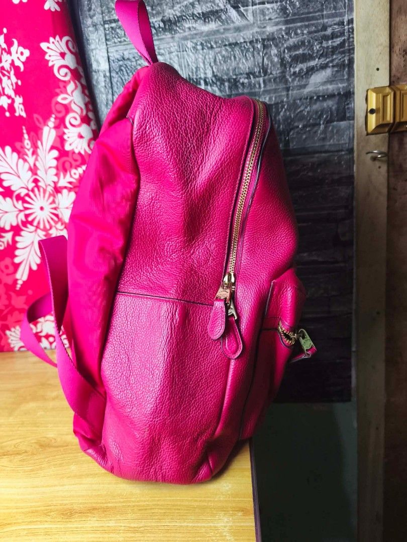 Coach Pink Leather Backpack (Category: Backpacks) located in Pasig City. Submitted by pingsrarefinds (Listing ID 1463296061, Image 3). Description: - Genuine leather Coach backpack in pink - Elegant gold hardware - Convenient front zip pocket - Adjustable straps for comfortable wear - Ample interior space for essentials - Ideal for everyday use and travel - Clean and well-maintained condition No grid.