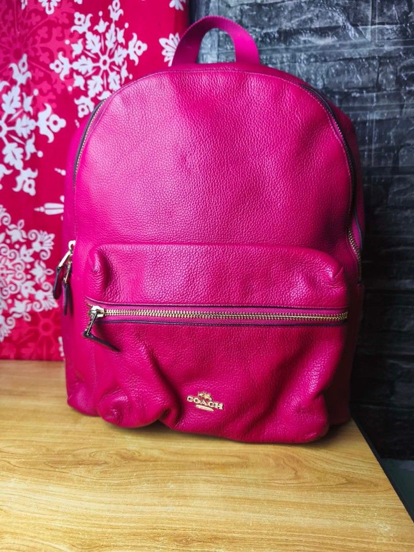 Coach Pink Leather Backpack (Category: Backpacks) located in Pasig City. Submitted by pingsrarefinds (Listing ID 1463296061, Image 1). Description: - Genuine leather Coach backpack in pink - Elegant gold hardware - Convenient front zip pocket - Adjustable straps for comfortable wear - Ample interior space for essentials - Ideal for everyday use and travel - Clean and well-maintained condition No grid.