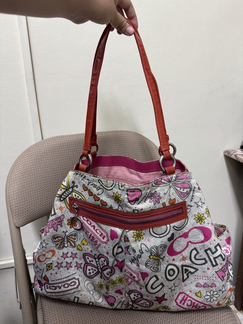 Coach Poppy Graffiti Print Shoulder Bag (Category: Luxury Bags & Wallets) located in Cabanatuan. Submitted by dgbordador (Listing ID 1463124767, Image 2). Description: - Cute Coach shoulder bag - Fun all-over graffiti print with butterflies, flowers, and Coach logo - sign of used sa leather straps - Pink interior with a zippered pocket - Comes with a small red heart charm - Great for everyday use.