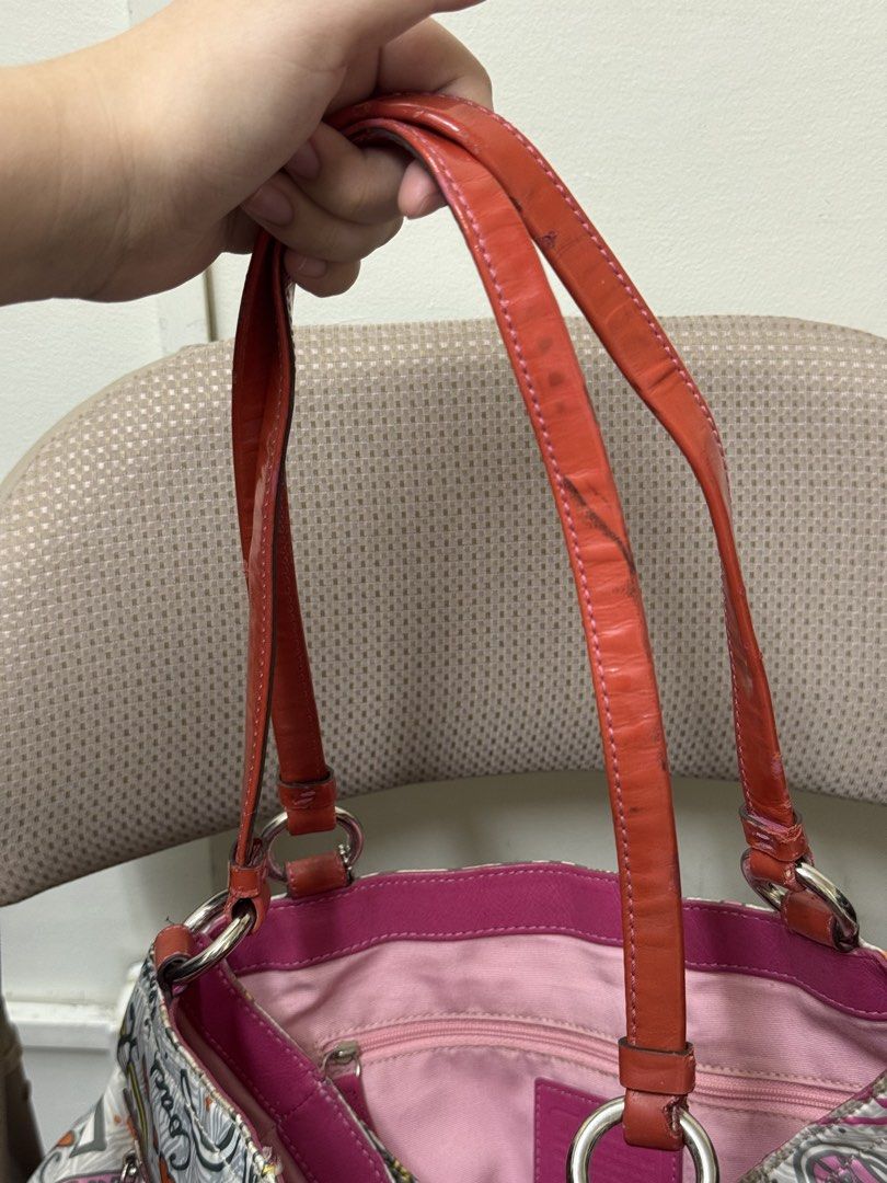 Coach Poppy Graffiti Print Shoulder Bag (Category: Luxury Bags & Wallets) located in Cabanatuan. Submitted by dgbordador (Listing ID 1463124767, Image 3). Description: - Cute Coach shoulder bag - Fun all-over graffiti print with butterflies, flowers, and Coach logo - sign of used sa leather straps - Pink interior with a zippered pocket - Comes with a small red heart charm - Great for everyday use.