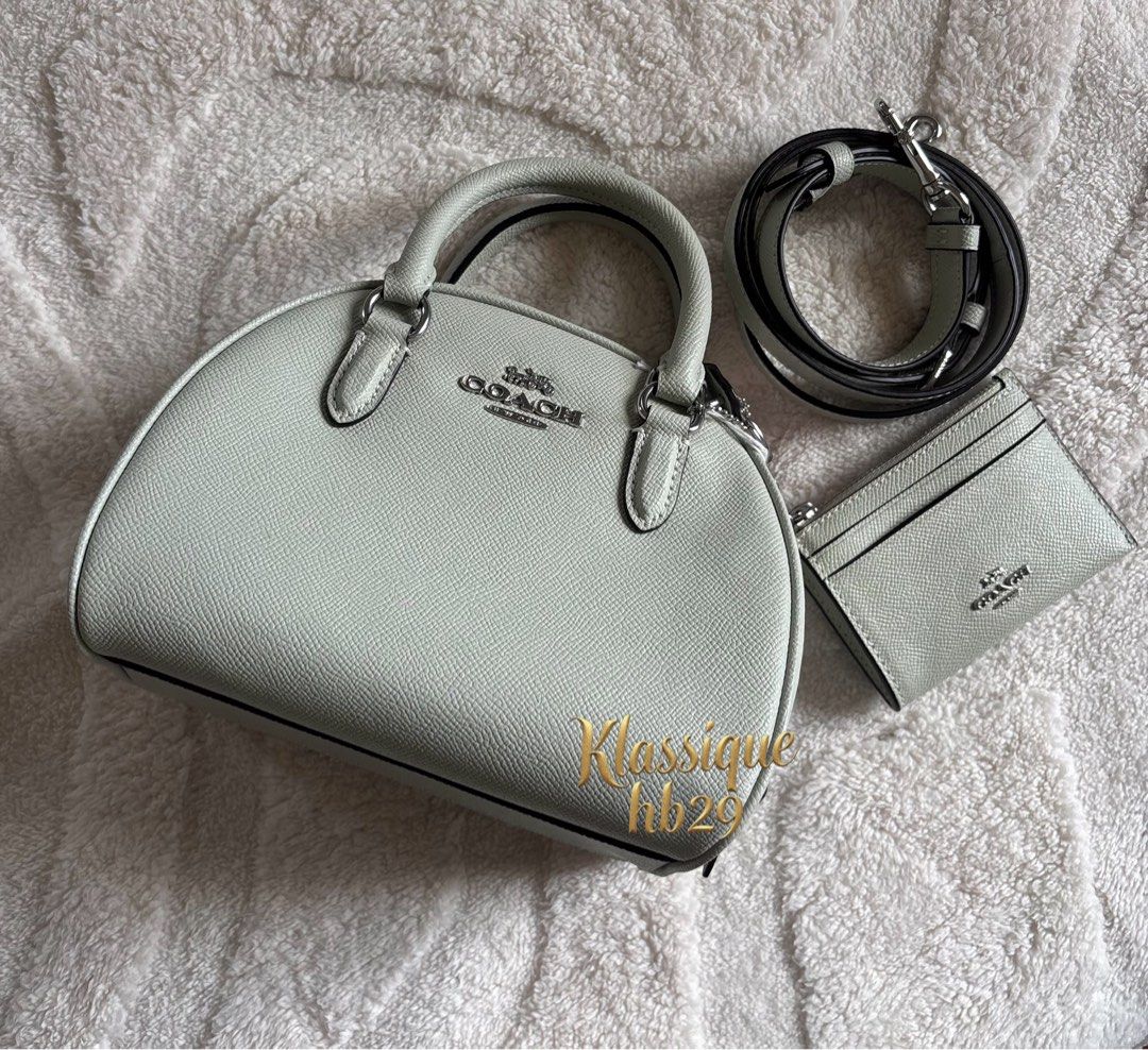 Coach Sydney (Category: Cross-body Bags) located in Lipa City. Submitted by klassique_handbags (Listing ID 1463204489, Image 1). Description: ✅Available✅ ❤️Coach Sydney❤️ Preowned but not used With card case na Fabric type Crossgrain Leather Closure type Zipper Lining Fabric About this item 8’’ (L) x 6’’ (H) x 5’’ (W) Outer Material: Leather Inner Material: Fabric No dust bag included (6,000)php No Lp na po🙏 Murayta na Super mahal ng coach po ng