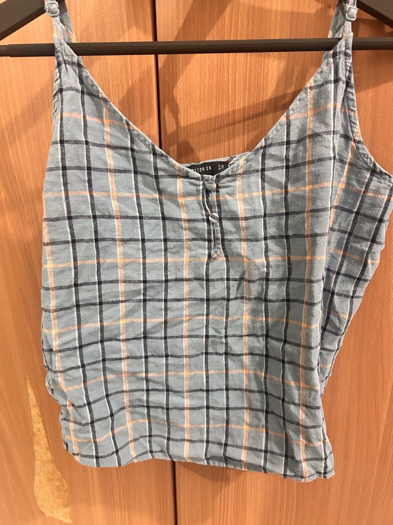 Cotton On Blue Plaid Button Front Cami Top (Category: Sleeveless) located in Taguig. Submitted by peanutcoconut (Listing ID 1463275383, Image 2). Description: - Cute blue plaid cami top - Brand: Cotton On - Features button front detail - Adjustable spaghetti straps - Lightweight fabric, ideal for warm weather - Pairs well with denim shorts or jeans - Size: S.
