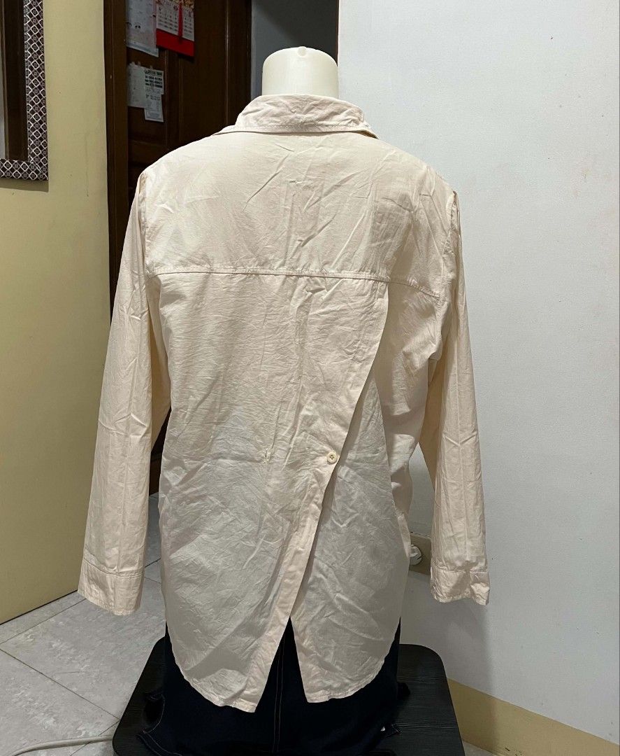 Cream Long Sleeve Button Up Shirt (Category: Tshirts & Polo Shirts ) located in Quezon City. Submitted by syayayay (Listing ID 1463206617, Image 2). Description: - Cream colored long sleeve shirt - Button-up front - Left chest pocket - Unique back detail with button closure - Relaxed fit - Ideal for casual wear.
