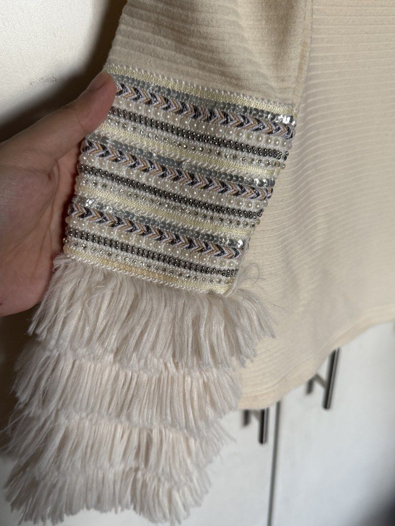 Cream Off Shoulder Knit Top (Category: Longsleeves) located in Quezon City. Submitted by itsbiancag (Listing ID 1463315800, Image 3). Description: - Off-the-shoulder cream rib-knit top - Sparkling sequin bands and fluffy faux-fur cuffs - Super pretty in person! - Nice thick and soft fabric - Fits XS-S.