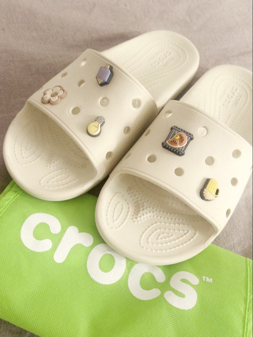 Crocs Slides Bone Colorway (Category: Slippers & Slides) located in Pasig City. Submitted by hauerking (Listing ID 1463127580, Image 2). Description: Very good parin po yung condition, siguro light cleaning lang naman po then pwede nang suotin! You may let me know if may better pricing pa po, the price is slightly negotiable naman po. - Crocs Bone Colorway - Comes with Jibbitz po. - Size: M10 / W12.