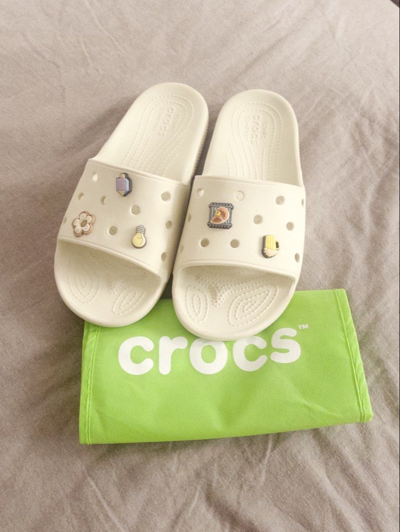 Crocs Slides Bone Colorway (Category: Slippers & Slides) located in Pasig City. Submitted by hauerking (Listing ID 1463127580, Image 1). Description: Very good parin po yung condition, siguro light cleaning lang naman po then pwede nang suotin! You may let me know if may better pricing pa po, the price is slightly negotiable naman po. - Crocs Bone Colorway - Comes with Jibbitz po. - Size: M10 / W12.