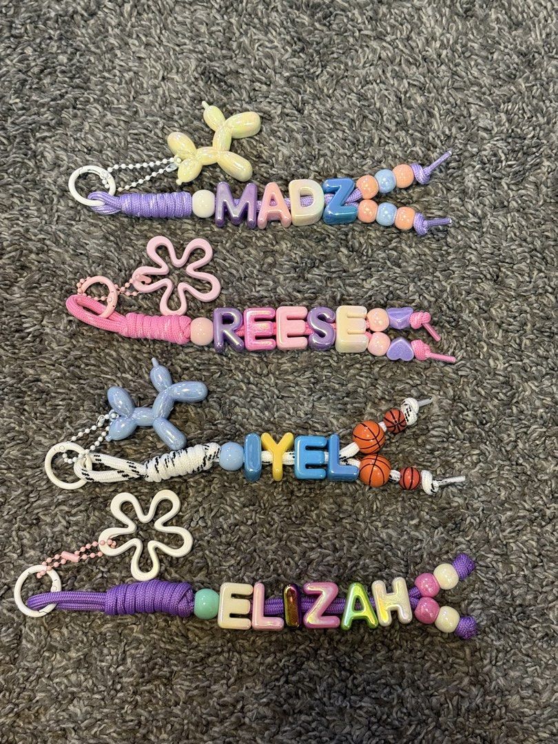 Customizable Beaded Name Keychain with Charms (Category: Charms) located in Manila. Submitted by angelaiza52734 (Listing ID 1463241223, Image 3). Description: - Handmade beaded keychains - Customizable with any name (e.g., Keisha, Kate, Madz, Reese) - Features unique letter beads - Adorned with fun charms like balloons and flowers - Ideal for personalizing bags, water bottles, or keys - Makes a perfect gift!.