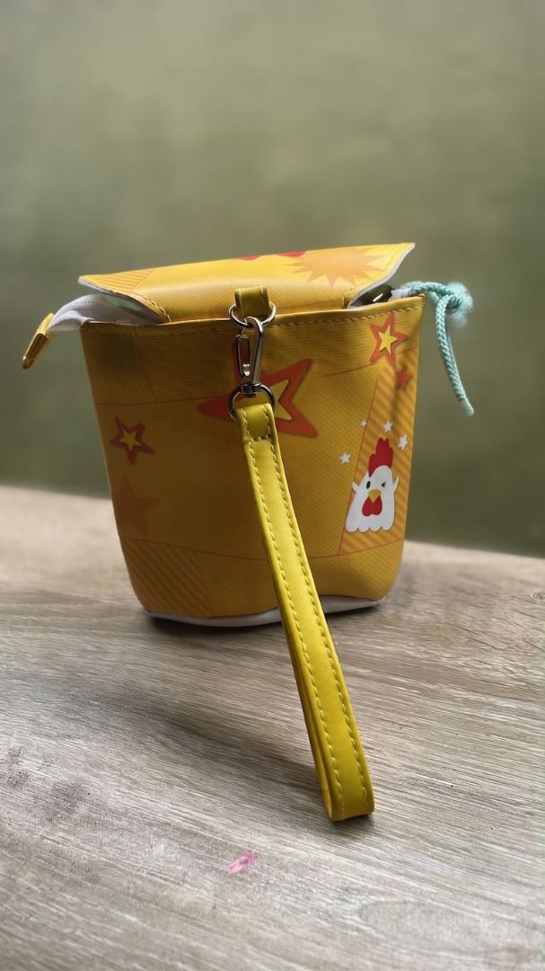 Cute Chicken Design Pouch with Wrist Strap (Category: Purses & Pouches) located in Quezon City. Submitted by eilgaraje (Listing ID 1463184915, Image 3). Description: - Adorable yellow coin pouch featuring a cute chicken design. - Red and white top flap with 'Regular' text. - Includes a convenient yellow wrist strap. - A fun and quirky accessory to add to your collection. japan surplus as posted used.