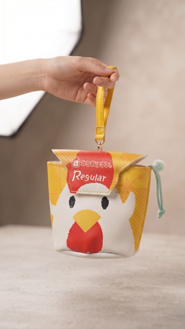 Cute Chicken Design Pouch with Wrist Strap (Category: Purses & Pouches) located in Quezon City. Submitted by eilgaraje (Listing ID 1463184915, Image 2). Description: - Adorable yellow coin pouch featuring a cute chicken design. - Red and white top flap with 'Regular' text. - Includes a convenient yellow wrist strap. - A fun and quirky accessory to add to your collection. japan surplus as posted used.
