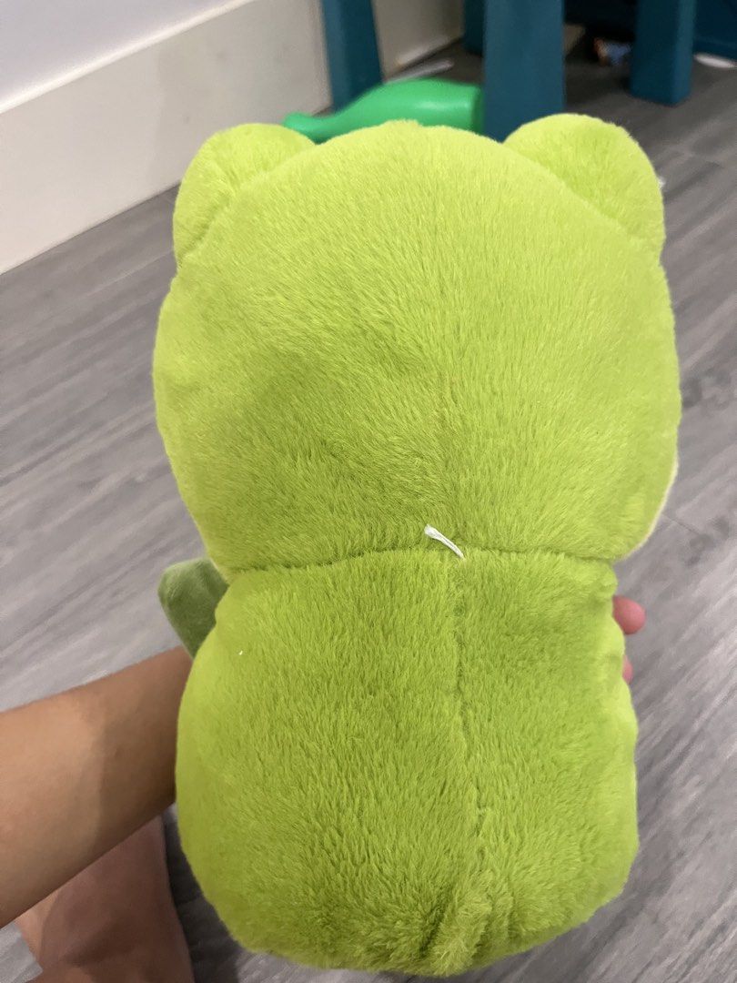 Cute Green Frog Plush Toy (Category: Plushies & Soft Toys) located in Quezon City. Submitted by ashlymae (Listing ID 1463155401, Image 2). Description: - Super soft and cuddly green frog plush - Features big eyes and a friendly smile - Approximately 8-10 inches tall - Ideal for children or as a cute decoration - Comes clean and ready for a new home.