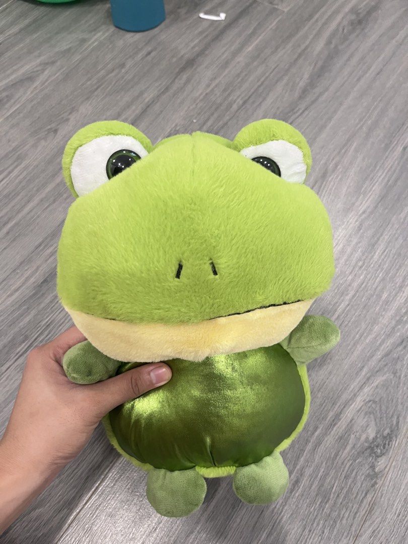 Cute Green Frog Plush Toy (Category: Plushies & Soft Toys) located in Quezon City. Submitted by ashlymae (Listing ID 1463155401, Image 3). Description: - Super soft and cuddly green frog plush - Features big eyes and a friendly smile - Approximately 8-10 inches tall - Ideal for children or as a cute decoration - Comes clean and ready for a new home.
