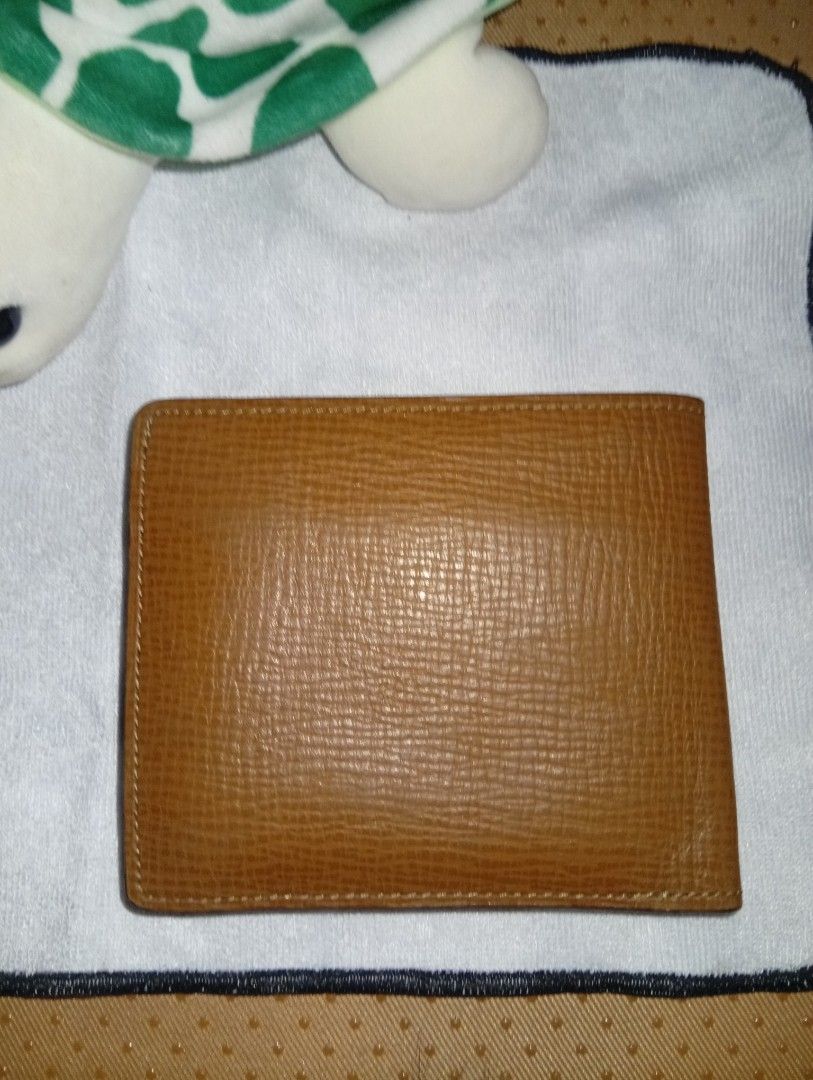 Daks London Brown Leather Bifold Wallet (Category: Wallets & Card holders) located in Davao. Submitted by lingxu23 (Listing ID 1463145496, Image 1). Description: - Brand: Daks London - Material: Brown Leather - Design: Bifold wallet - Interior: Classic check lining - Features: Coin pouch with snap closure, multiple card slots and compartments - Condition: Shows some signs of wear, but still in good shape - Ideal for: Everyday use.