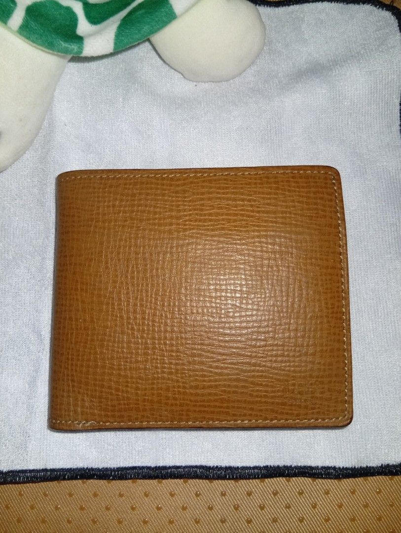 Daks London Brown Leather Bifold Wallet (Category: Wallets & Card holders) located in Davao. Submitted by lingxu23 (Listing ID 1463145496, Image 2). Description: - Brand: Daks London - Material: Brown Leather - Design: Bifold wallet - Interior: Classic check lining - Features: Coin pouch with snap closure, multiple card slots and compartments - Condition: Shows some signs of wear, but still in good shape - Ideal for: Everyday use.