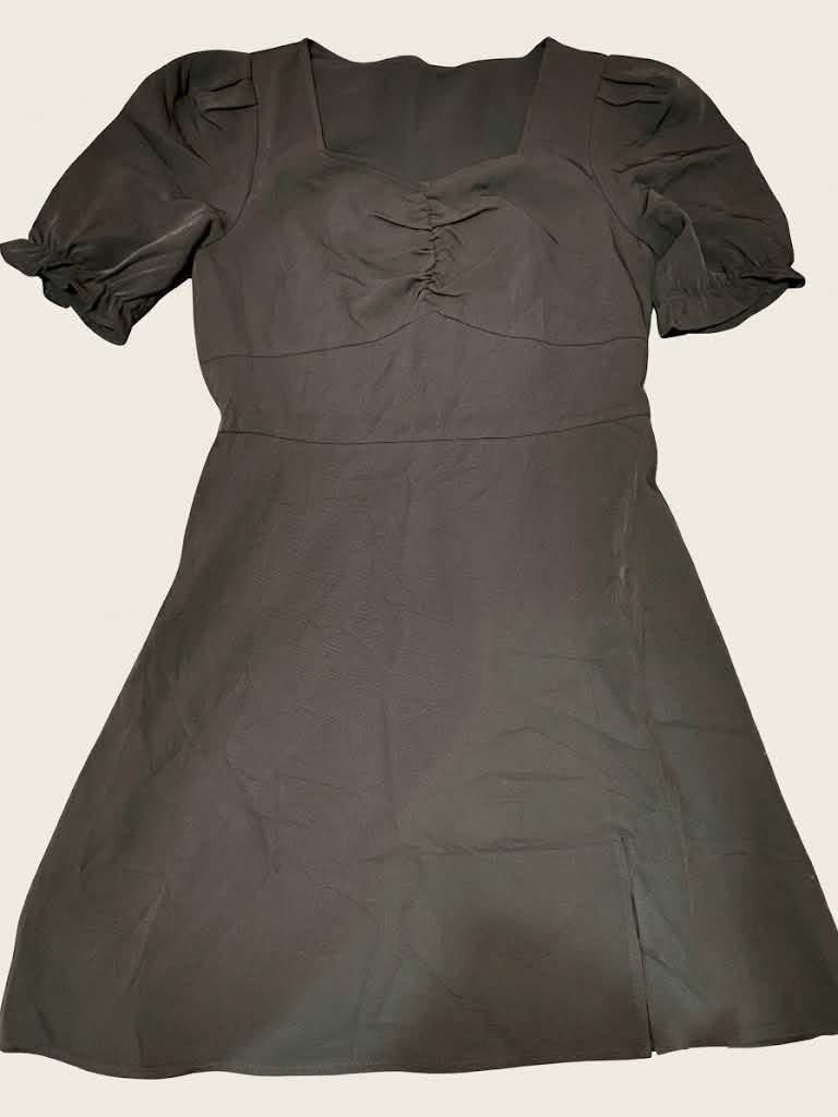 Dark Grey Square Neck Puff Sleeve Dress (Category: Dresses) located in Guagua. Submitted by adventurousa (Listing ID 1463125845, Image 1). Description: - Chic black dress - Flattering square neckline - Ruched detailing at the bust - Stylish puff sleeves with ruffled cuffs - Subtle side slit on the skirt - Textured fabric for added interest - Versatile for casual outings or date nights.