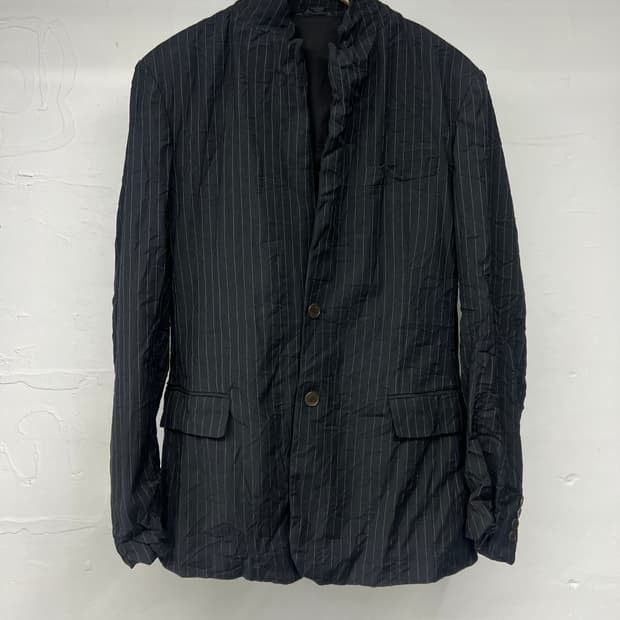 Dark Pinstripe Blazer Jacket (Category: Luxury Apparel) located in Manila. Submitted by icamalicdem29 (Listing ID 1463269954, Image 2). Description: - Dark blazer with a classic pinstripe pattern. - Features a two-button front closure. - Two flap pockets on the lower front for practicality. - Button details on the cuffs add a refined touch. - Please note: a small snag is visible on the fabric near the lapel. - Ideal for creating stylish smart cas