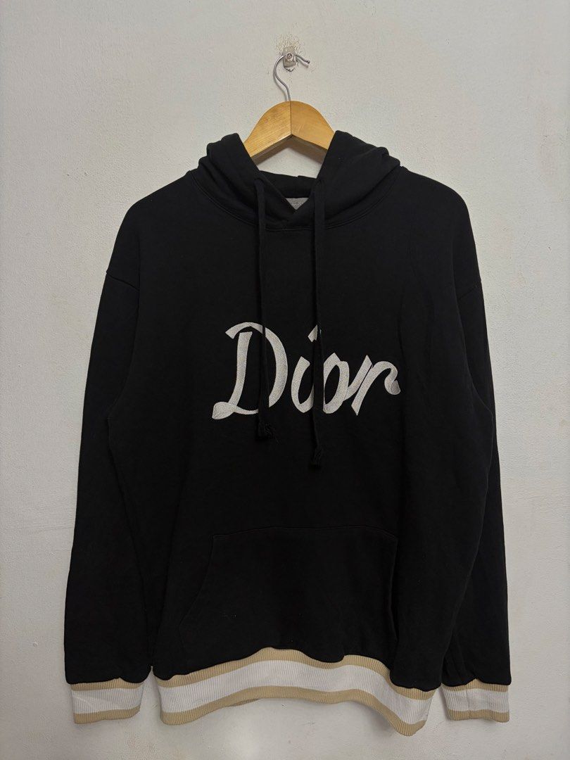 Dior '47' Black Hoodie (Category: Hoodies) located in Bulacan. Submitted by chrlzchrstnfntn33 (Listing ID 1463136093, Image 1). Description: - Authentic Dior hoodie - Size: Medium (M) - Design: 'Dior' logo on front, '47' graphic on back - Details: Ribbed cuffs and hem with beige and white stripes - Origin: Made in Italy.