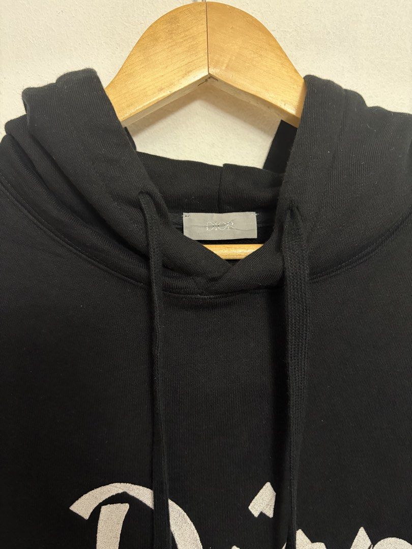 Dior '47' Black Hoodie (Category: Hoodies) located in Bulacan. Submitted by chrlzchrstnfntn33 (Listing ID 1463136093, Image 3). Description: - Authentic Dior hoodie - Size: Medium (M) - Design: 'Dior' logo on front, '47' graphic on back - Details: Ribbed cuffs and hem with beige and white stripes - Origin: Made in Italy.