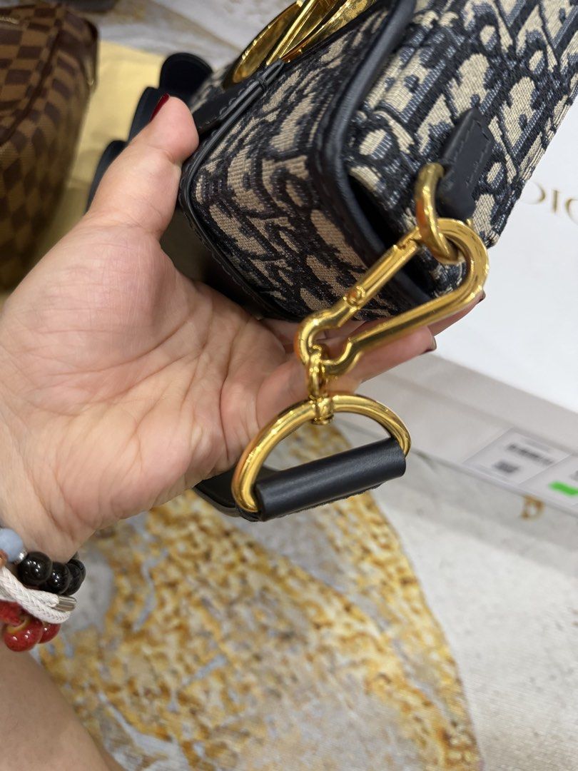 Dior Oblique Canvas Saddle Bag (Category: Luxury Bags & Wallets) located in Pasig City. Submitted by tamara0520 (Listing ID 1463258490, Image 3). Description: - Authentic Dior Saddle Bag - Classic Oblique Canvas - Black Leather Trim and Strap - Gold CD Buckle Closure - Includes Detachable Shoulder Strap - Versatile for everyday or special occasions - Authenticity Guaranteed.