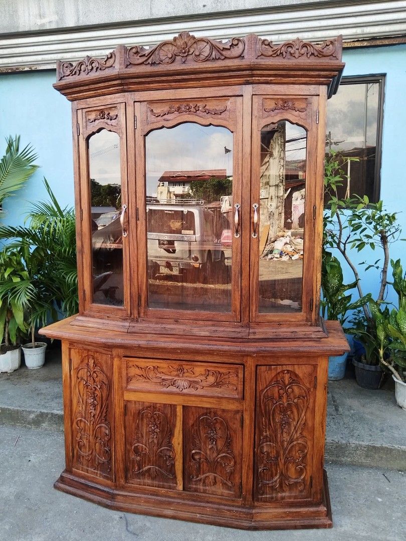 Display Cabinet (Category: Shelves, Cabinets & Racks) located in Meycauayan. Submitted by marygracecasimiro (Listing ID 1463218279, Image 3). Description: China Cabinet or Platera made of solid Narra wood with carvings on both side. Top portion is movable. Restored and revarnished. Ready to use.♥️ Get it for only P23,450. Size H81 x L54 x W20 inches.