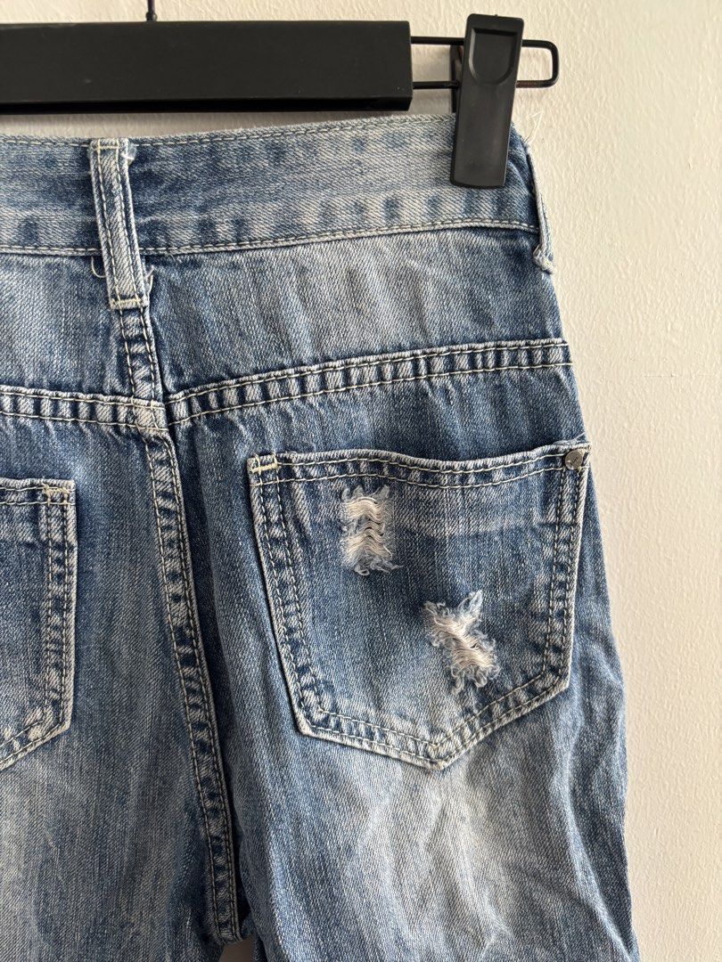 Distressed Blue Denim Jeans (Category: Jeans) located in Muntinlupa City. Submitted by jc444_ (Listing ID 1463306335, Image 3). Description: - Cool distressed blue denim jeans - Cropped length with frayed hem - Edgy look with rips and tears - Light wash with subtle pattern details on lower legs - Great for casual wear.