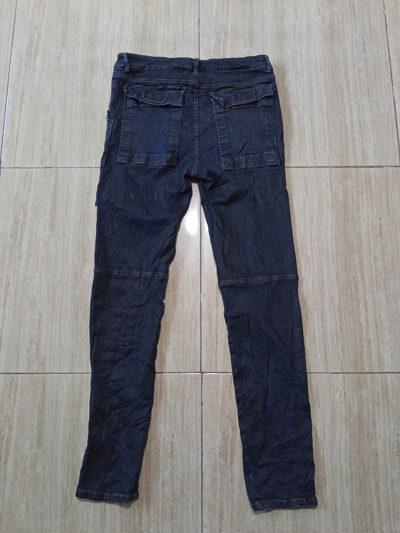 Distressed Patchwork Denim Jeans with Wrap Detail (Category: Activewear) located in Glan. Submitted by cpaharodde48008 (Listing ID 1463214547, Image 2). Description: - Unique denim jeans with a stylish patchwork design. - Features a distinctive wrap-around detail on the front. - Multiple functional pockets on both the front and back. - Distressed elements for a cool, edgy aesthetic. - Ideal for creating a standout outfit..