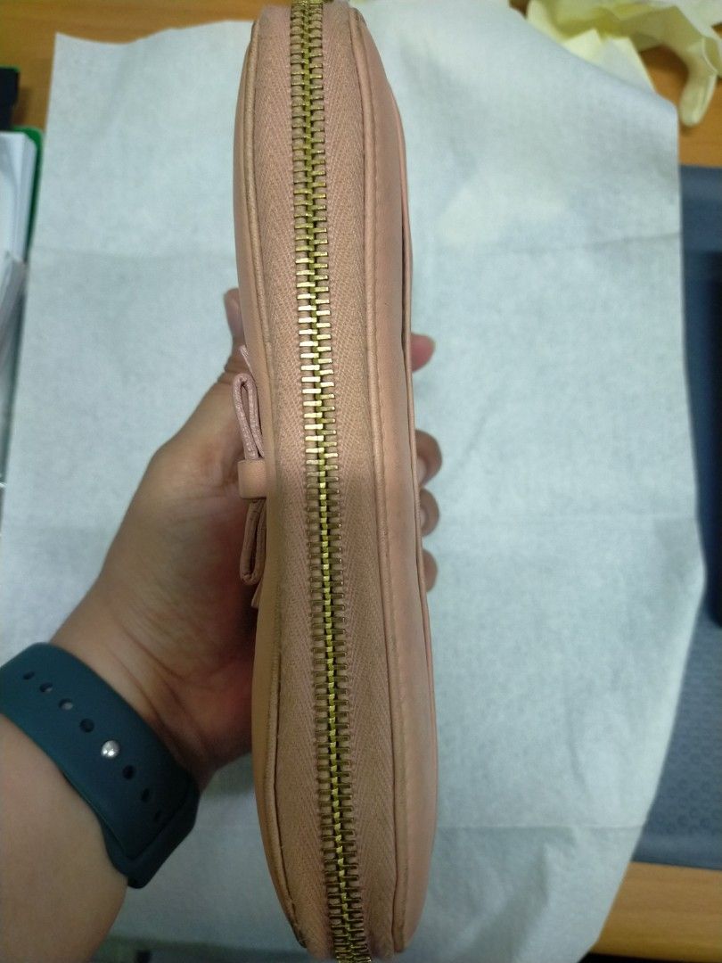Dolce & Gabbana Pink Leather Zip Around Wallet (Category: Luxury Bags & Wallets) located in Mabalacat. Submitted by lysmnl6 (Listing ID 1463180330, Image 3). Description: - Authentic Dolce & Gabbana wallet - Made in Italy - Pink leather exterior - Gold heart charm and bow detail - Zip-around closure - Multiple interior card slots and compartments.