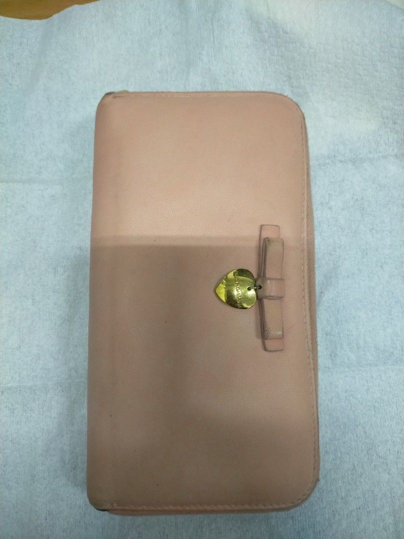 Dolce & Gabbana Pink Leather Zip Around Wallet (Category: Luxury Bags & Wallets) located in Mabalacat. Submitted by lysmnl6 (Listing ID 1463180330, Image 1). Description: - Authentic Dolce & Gabbana wallet - Made in Italy - Pink leather exterior - Gold heart charm and bow detail - Zip-around closure - Multiple interior card slots and compartments.