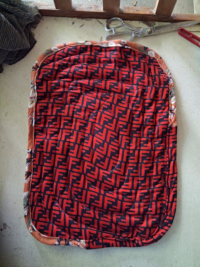 Door mat (Category: Table Linen & Textiles) located in Cabanatuan. Submitted by ronnelpena (Listing ID 1463255120, Image 1). Description: - Handmade quilted placemat - Features a repeating red and black F-logo pattern - Edges trimmed with beautiful floral fabric - Protects your surfaces from spills and heat - Adds a decorative touch to your dining table - Approximate dimensions: 18 inches by 12 inches.