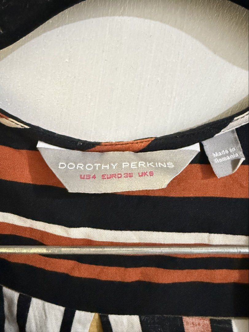 Dorothy Perkins Striped Button-Up Tie-Front Blouse (Category: Blouses) located in Quezon City. Submitted by secondsgon (Listing ID 1463250548, Image 2). Description: - Dorothy Perkins striped blouse - Tie-front detail at the hem - Roll-tab sleeves for adjustable length - Button-up front with a classic chest pocket - Vibrant stripes in black, orange, white, yellow, and green - Ideal for a stylish casual look.
