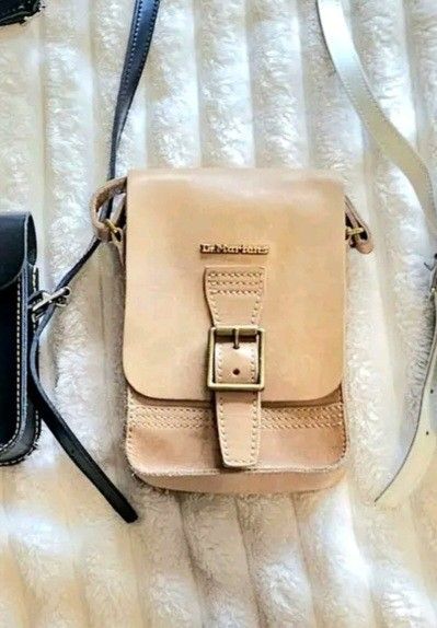 Dr. Martens Leather Crossbody Bag Tan (Category: Cross-body Bags) located in Quezon City. Submitted by viflor (Listing ID 1463149387, Image 1). Description: Onhand 80% new Qc. Pm me Original - Brand: Dr. Martens - Material: Tan Leather - Closure: Buckle - Strap: Adjustable - Size: Small and compact, ideal for essentials - Style: Classic, everyday use - Quality: Renowned Dr. Martens durability.
