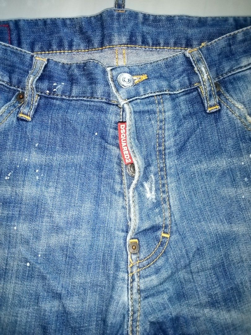 DSQUARED2 Distressed Blue Denim Jeans Size 48 (Category: Jeans) located in Veruela. Submitted by durojaarce23468 (Listing ID 1463320382, Image 3). Description: - Brand: DSQUARED2 - Size: 48 - Wash: Classic Blue - Details: Distressed, paint splatters, rips, patched hole on left leg - Closure: Button fly - Origin: Made in Italy - Style: Edgy, casual.