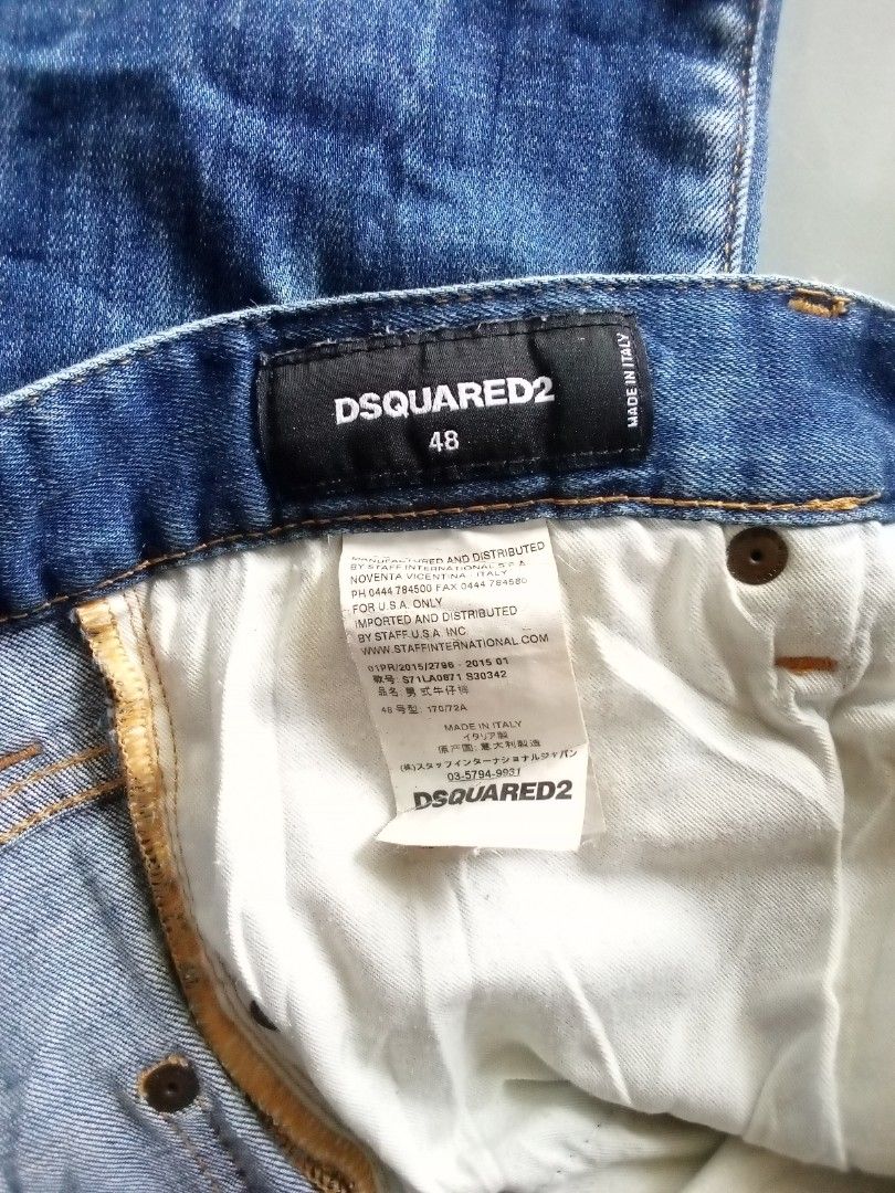 DSQUARED2 Distressed Blue Denim Jeans Size 48 (Category: Jeans) located in Veruela. Submitted by durojaarce23468 (Listing ID 1463320382, Image 2). Description: - Brand: DSQUARED2 - Size: 48 - Wash: Classic Blue - Details: Distressed, paint splatters, rips, patched hole on left leg - Closure: Button fly - Origin: Made in Italy - Style: Edgy, casual.